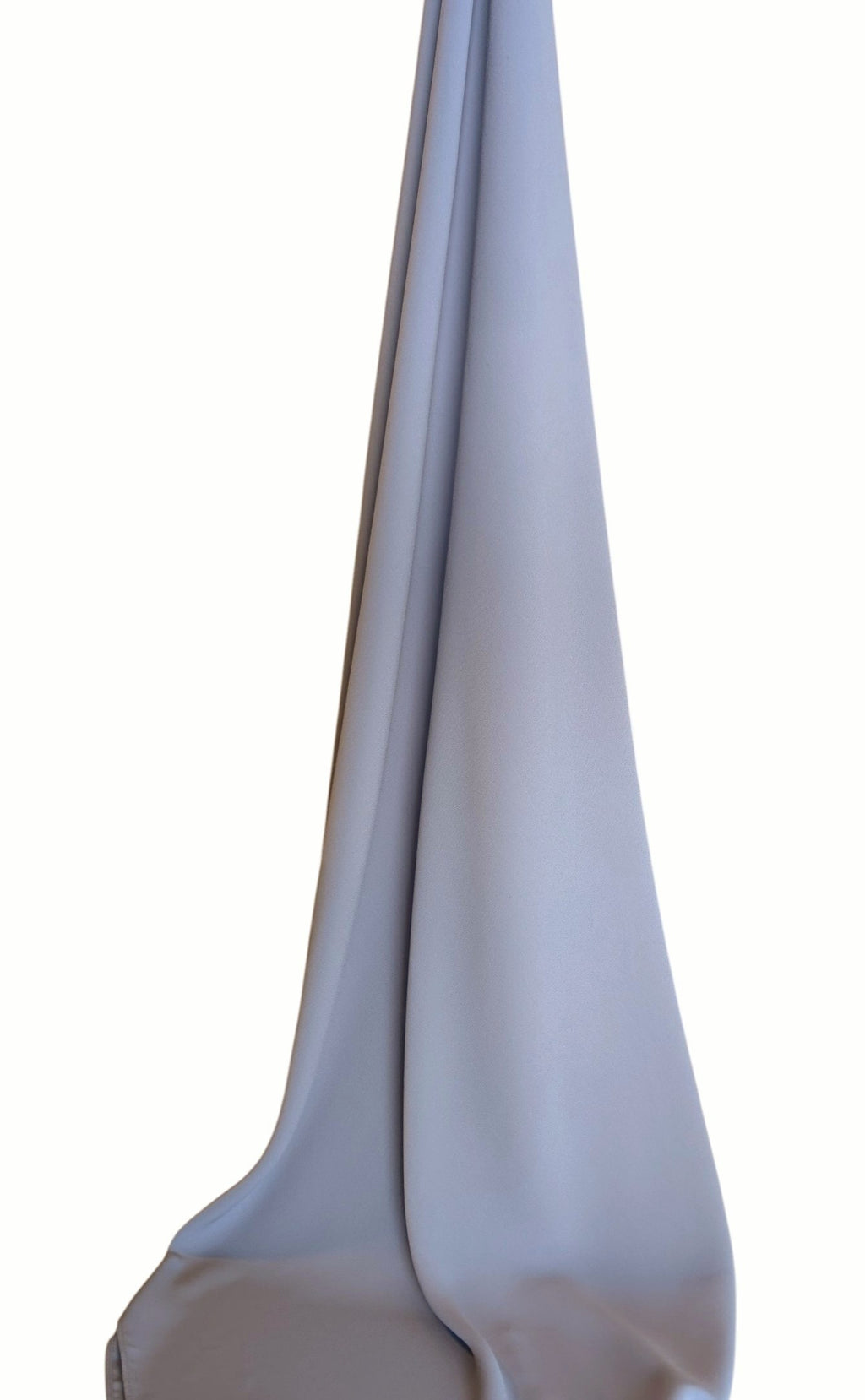 A draped chiffon hijab in light gray color hanging vertically against a plain white background.