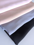 Four folded chiffon hijabs in light pink, pale beige, light gray, and black, arranged diagonally on a white background featuring a hijab bundle offer.