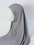 A solid gray chiffon hijab draped over a cream-colored mannequin head in side face shot view, photographed against a white background.